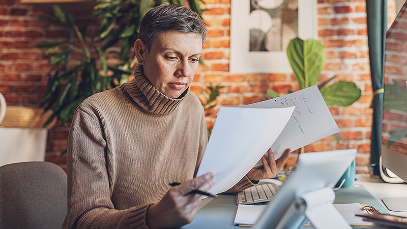 Older woman looking at medicare papers