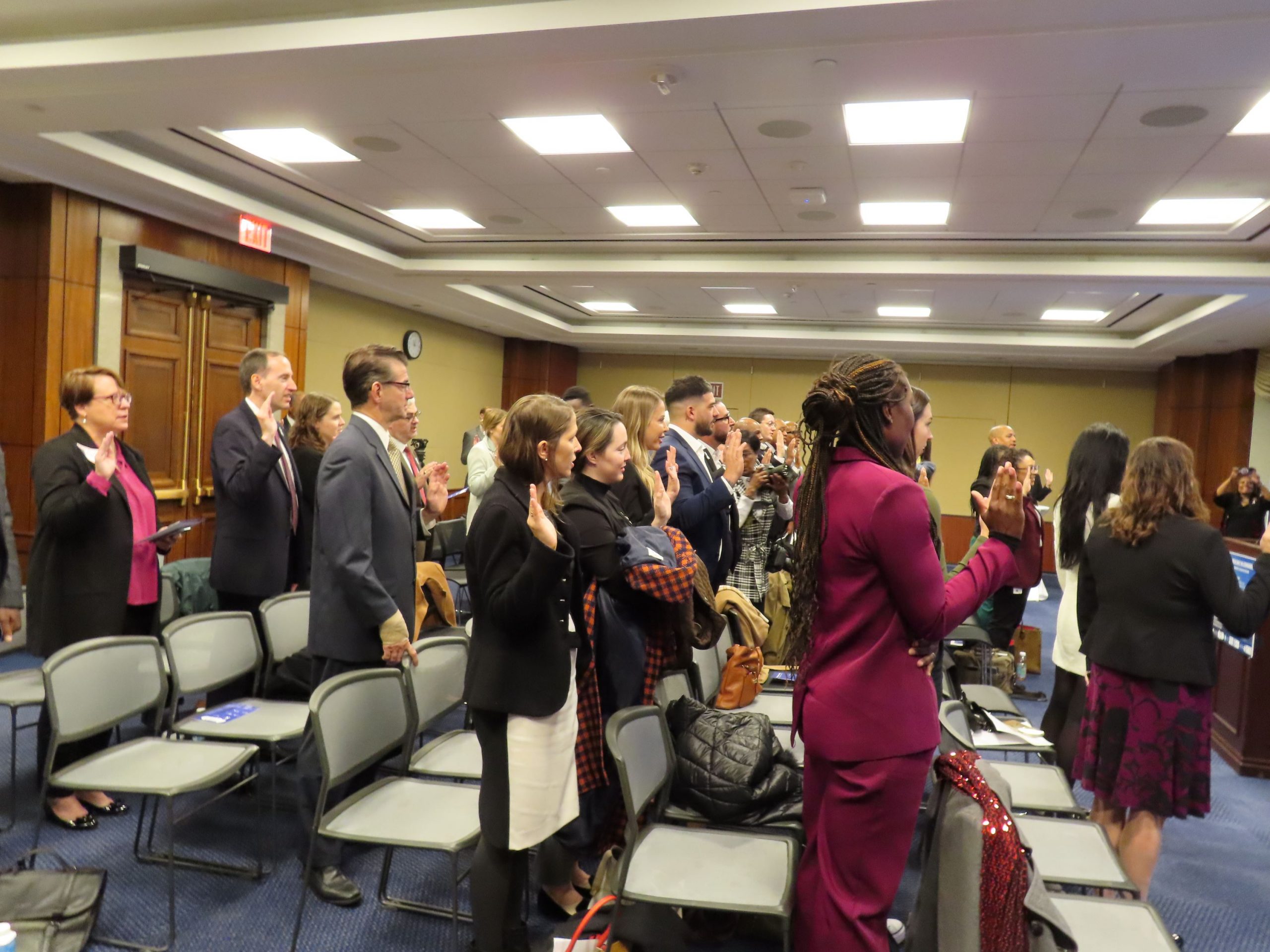 Attendees of the White Ribbon Day in Congress event on Dec. 1, 2023, take the White Ribbon pledge