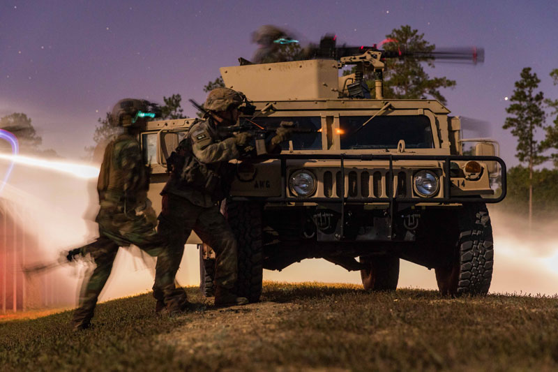 Military soldiers next to a military vehicle