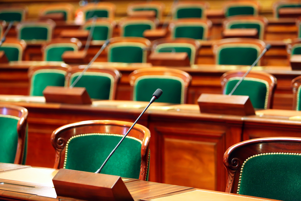 Empty vintage congress hall with seats and microphones