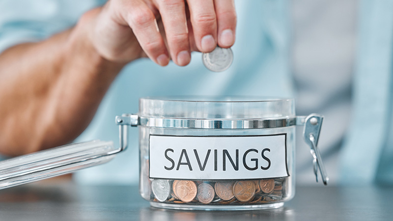 Man dropping change in a coin jar